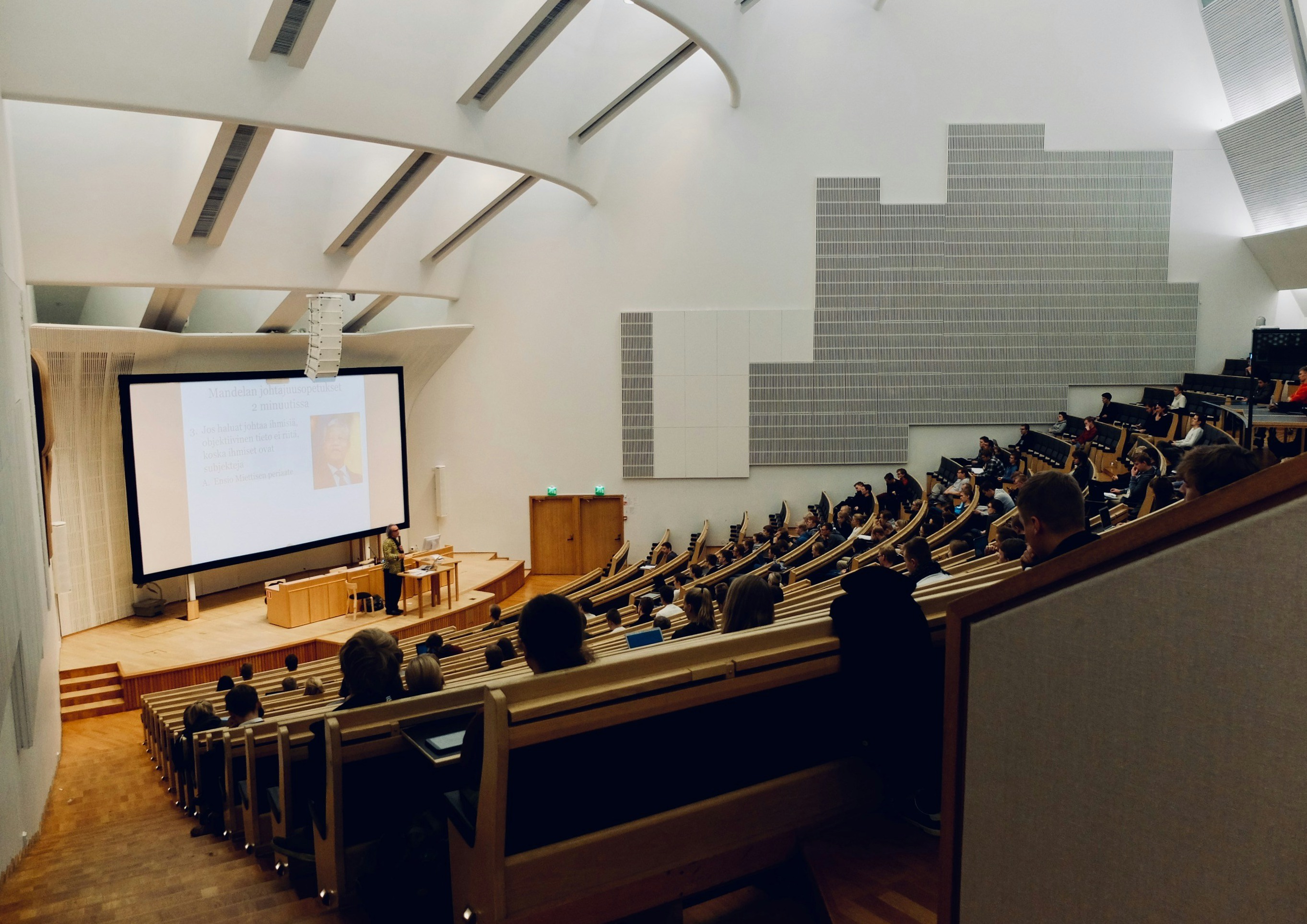 Large lecture hall with a lecturer and students